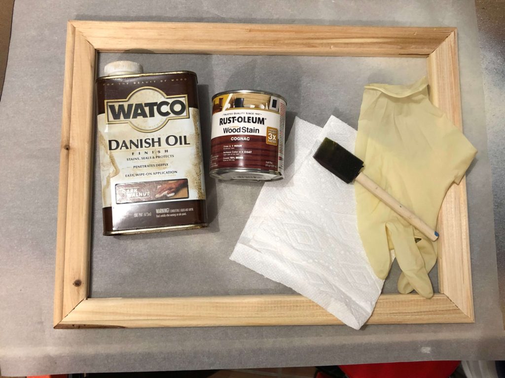 Wood stain, foam brus, cloth, gloves, wood frame for reverse canvas project